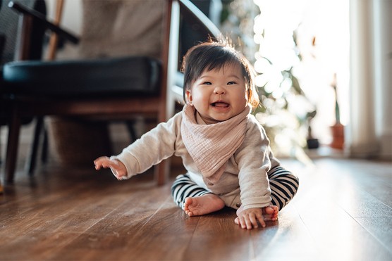 6 months old baby sitting up unaided