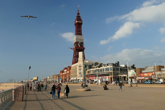 A bustling scene on a sunny day by Blackpool's beachfront