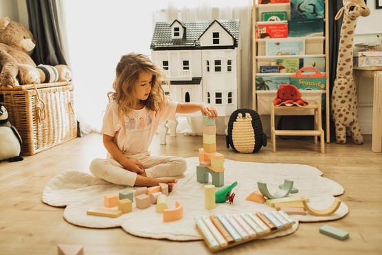 child playing nicely in a tidy playroom toy rotation