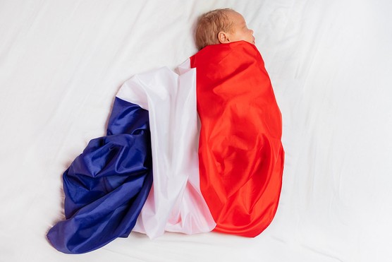 newborn baby covered in a French flag