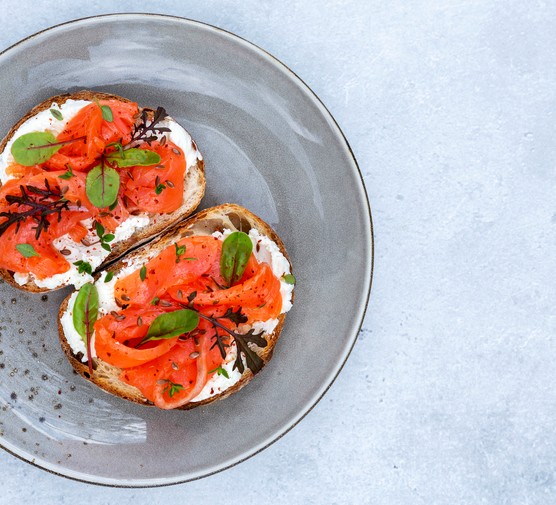 smoked salmon with cream cheese on an open sandwich