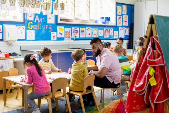 teacher with children in a primary school classroom