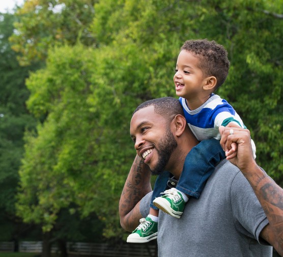 happy dad with happy toddler on his shoulders