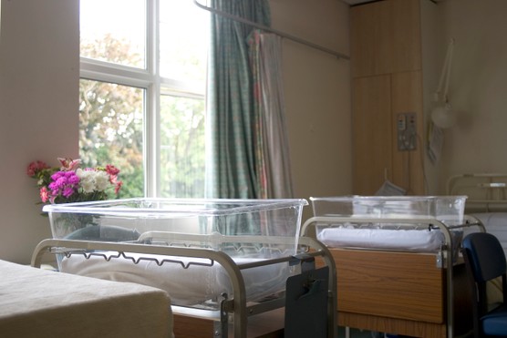 Empty cots in hospital maternity ward