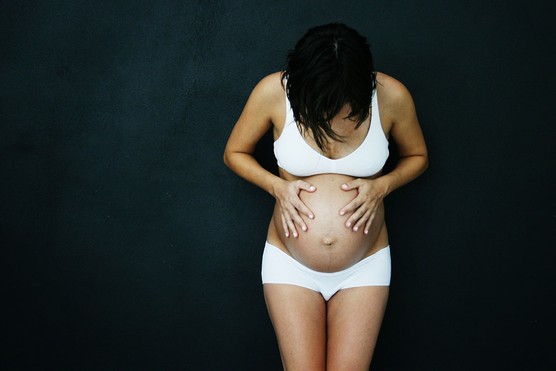 pregnant woman looking down