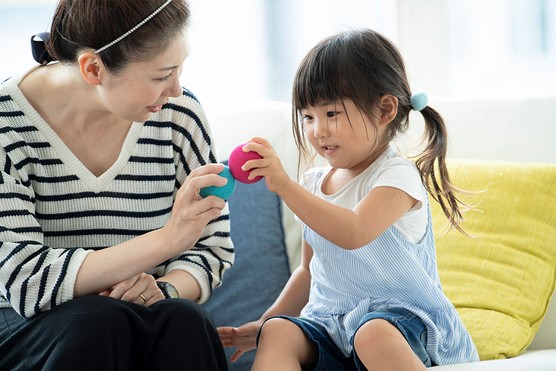 teacher talking to and playing with child during a home visit