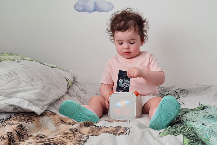 yoto-3rd-generation3 A toddler playing with a Yoto Player