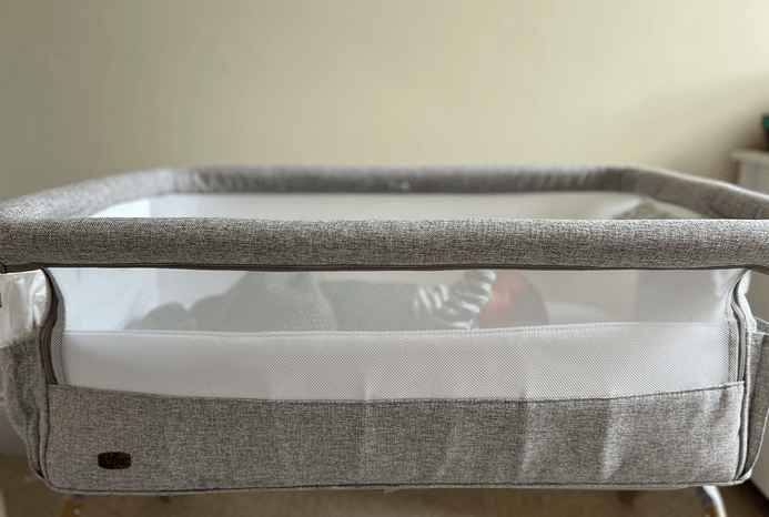 Side view of baby in Chicco Armonia Next2Me bedside crib